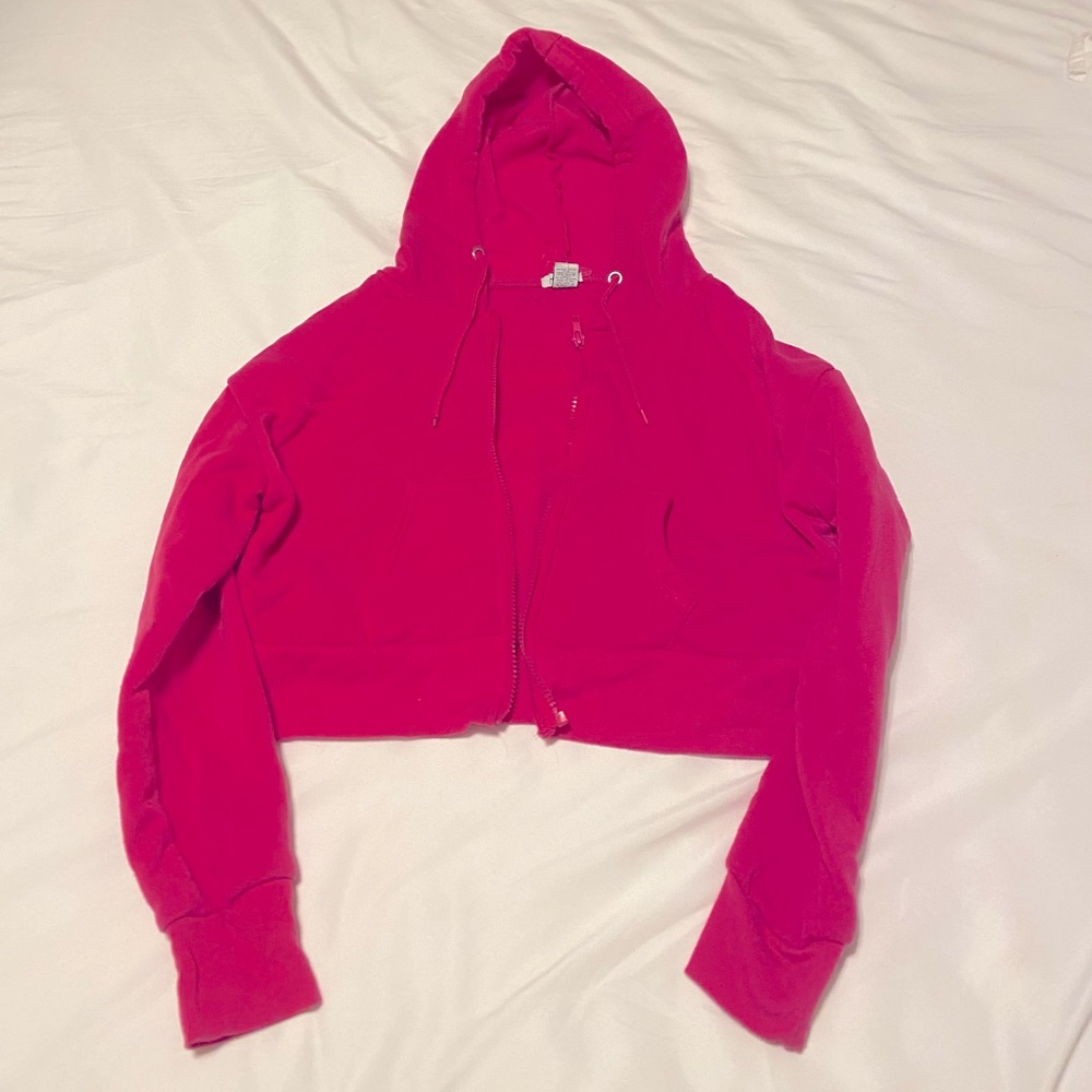 Hot pink cropped zip up jacket.